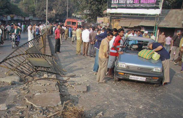 Onlookers gather around a damaged car at an accident site in Pune, about 190km (118 miles) from Mumbai. A government bus driver sped through the streets of the city on Wednesday smashing his empty bus into dozens of vehicles, killing nine people and injuring 27, police said. (REUTERS)