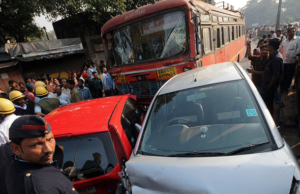 Onlookers and rescue workers gather around a damaged bus and other vehicles at an accident site in Pune, about 190km (118 miles) from Mumbai. A government bus driver sped through the streets of the city on Wednesday smashing the empty bus into dozens of vehicles, killing nine people and injuring 27, police said. (REUTERS)