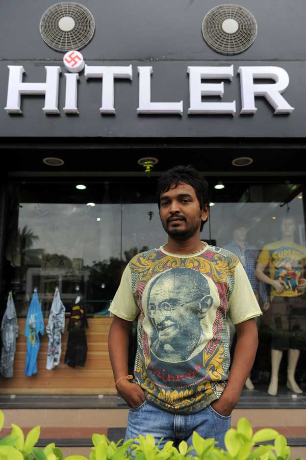 Rajesh Shah poses in a t-shirt adorned with an image of Indian freedom icon Mahatma Gandhi in front of his shop in Ahmedabad (AFP)