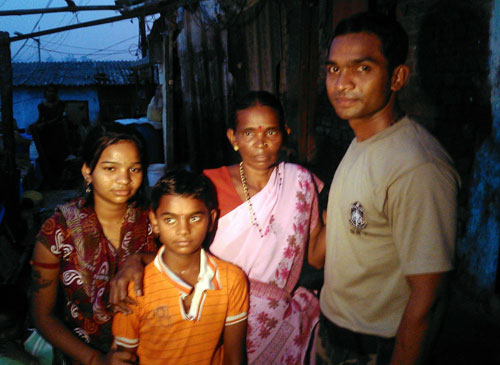 Indian police commando, Ganesh Raghunath Dhangade (right), poses for a photo with his family  in Thane district on the outskirts of Mumbai on October 16, 2013. Dhangade who got lost as a child at a crowded railway station was reunited with his family after 24 years -- thanks to a tattoo on his arm. Dhangade was separated from his parents in 1989 aged just six when they were boarding a train. He ended up on his own in Mumbai, where he was cared for by a fisherman and then at two orphanages. (AFP)