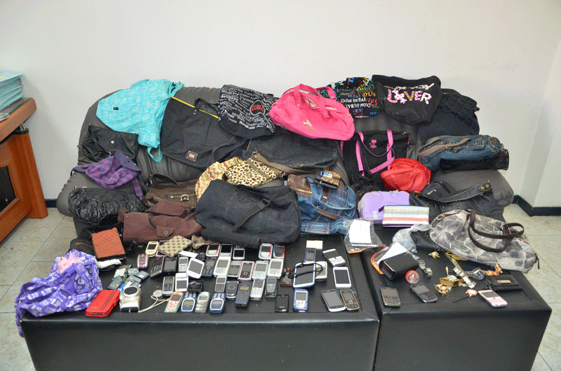 Stolen adies' handbags and mobile phones found in the home of the woman arrested in Sharjah.