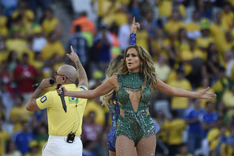 US singer Jennifer Lopez (centre), Brazilian pop singer Claudia Leiite (back) and US rapper Pitbull (left) perform during the opening ceremony of the 2014 FIFA football World Cup at the Corinthians Arena in Sao Paulo on June 12, 2014. (AFP)