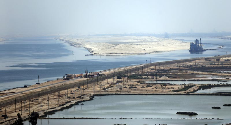 A general view of the Suez Canal is seen from Al Salam "Peace" bridge on the Ismalia desert road before the opening ceremony of the New Suez Canal, in Egypt, August 6, 2015. Egypt will open an expansion to the Suez Canal to great fanfare on Thursday, the centrepiece of President Abdel Fattah al-Sisi's plans to revitalise the country's economy after years of damaging political turmoil. Picture taken through a fence. REUTERS/Amr Abdallah Dalsh