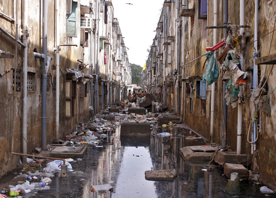 Municipal workers clear the debris in an alley after flood waters receded in Chennai, India. (Reuters)