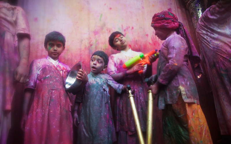 Young boys playing Holi, known as Kanhas, throw colour over devotees during Holi celebrations in Vrindavan, India. (GETTY IMAGES)