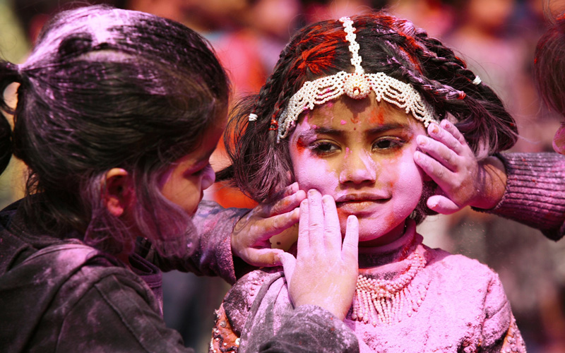 Children celebrate Holi, also known as the festival of colours, inside a school in the eastern Indian city of Siliguri. The tradition of Holi heralds the beginning of spring and will be celebrated all over India on March 1. (REUTERS)