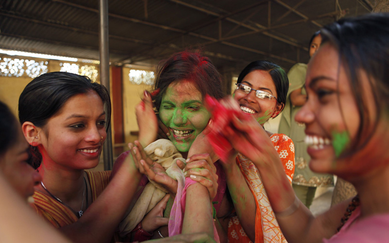 School students smear each other with colors as they celebrate Holi, the Indian festival of colors, in Allahabad, India. (AP)