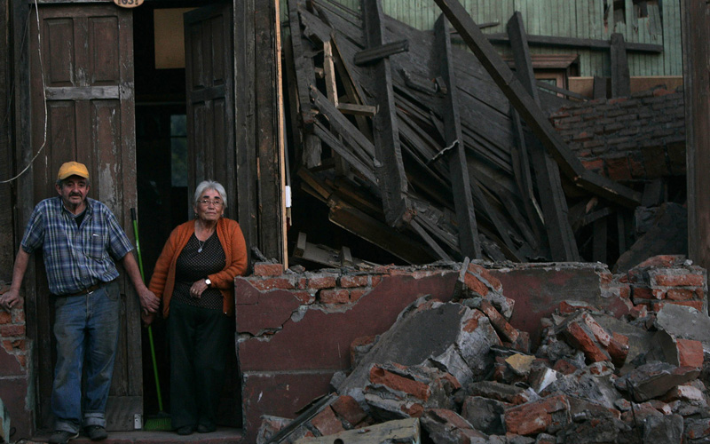 A couple stand in front of their house destroyed by a major earthquake in Talcahuano. Chilean troops patrolled in the wake of Saturday morning's 8.8-magnitude quake that killed more than 700 people, while the government acknowledged that it has battled to provide aid swiftly because of crumpled highways and major power disruptions caused by the quake. (REUTERS)