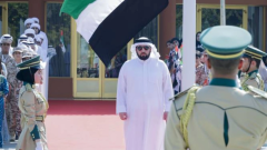 Photo: Ahmed bin Mohammed raises the national flag at the Etihad Museum in Dubai